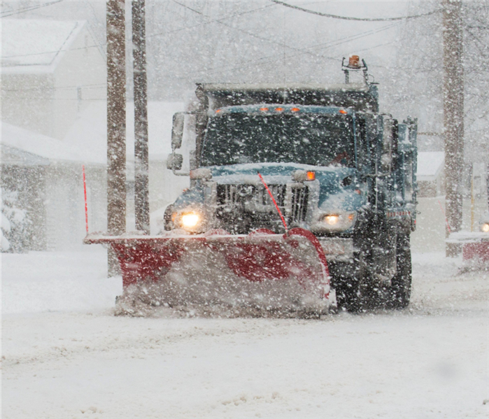 Snow plow on snowy road