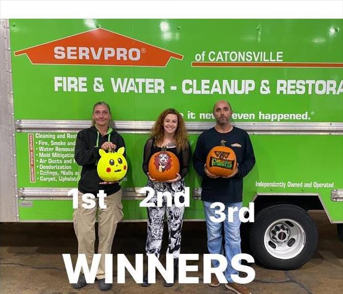Photo of winners holding their pumpkins